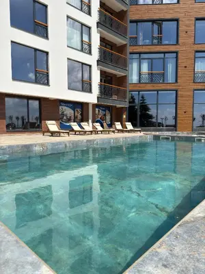 a large swimming pool in front of a building at Marrilux apartments Residence Hill in Kopaonik