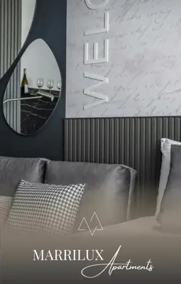a bedroom with a bed with a mirror on the wall at Marrilux apartments Residence Hill in Kopaonik