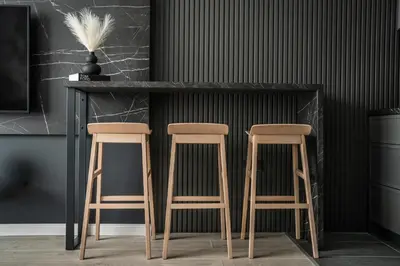 a bar with two stools next to a counter at Marrilux apartments Residence Hill in Kopaonik