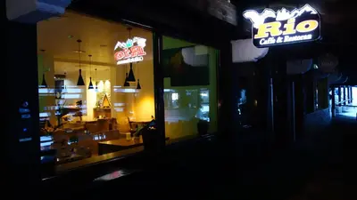 a restaurant window with a rico sign and a dining room at Select Lux Apartments Konaci Kopaonik in Kopaonik