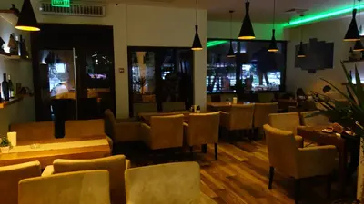 a restaurant with chairs and tables and a bar at Select Lux Apartments Konaci Kopaonik in Kopaonik