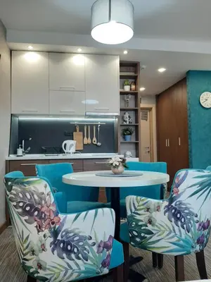a kitchen with a table and chairs in a kitchen at Select Lux Apartments Konaci Kopaonik in Kopaonik
