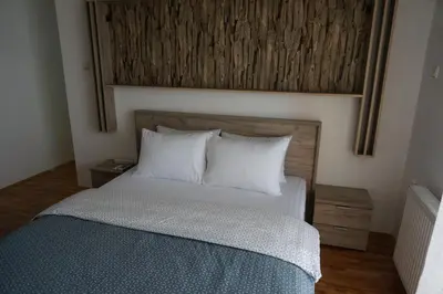 a bedroom with a bed with two pillows at Nice apartment in Niš