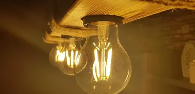 a group of lights hanging from a ceiling at Nice apartment in Niš