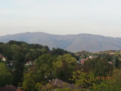 a view of a town with mountains in the background at Debora Apartment in Vrnjačka Banja