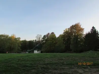 a statue in a field with trees in the background at Debora Apartment in Vrnjačka Banja
