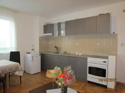 a kitchen with gray cabinets and a white stove top oven at Debora Apartment in Vrnjačka Banja