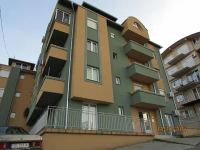 a tall building with balconies on the side of it at Debora Apartment in Vrnjačka Banja