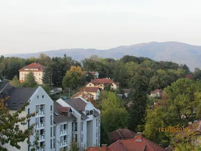 a city with houses and mountains in the background at Debora Apartment in Vrnjačka Banja