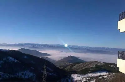 a view of a mountain with the moon in the sky at Apartman FILIPOVIC Milmari D in Kopaonik