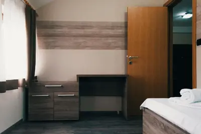a room with a desk and a bed and a door at Apartman FILIPOVIC Milmari D in Kopaonik