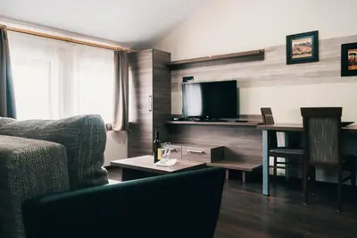 a living room with a couch and a table at Apartman FILIPOVIC Milmari D in Kopaonik