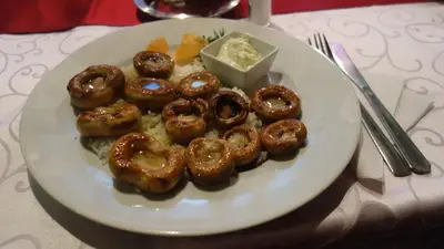 a plate of glazed donuts on a table at Elite Apartment Konaci in Kopaonik