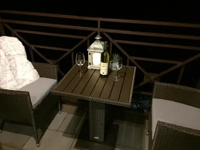 a table with two glasses and a bottle of wine at Apartment F10 Milmari Resort in Kopaonik