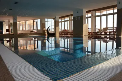 a large swimming pool in a building with at Apartment F10 Milmari Resort in Kopaonik