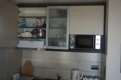 a kitchen with a sink and a microwave at Apartment F10 Milmari Resort in Kopaonik