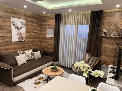 a living room with a couch and a table at Apartment F10 Milmari Resort in Kopaonik