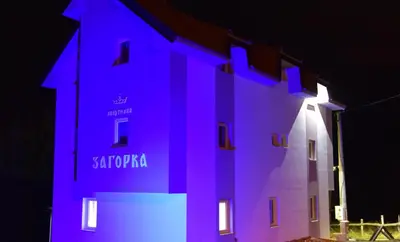 a building with purple lights on the side of it at Villa Zagorka and mountain houses A, M, D in Kopaonik
