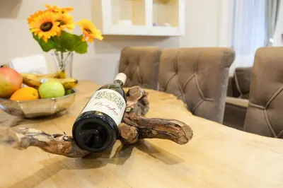 a bottle of wine sitting on top of a table at Villa Zagorka and mountain houses A, M, D in Kopaonik