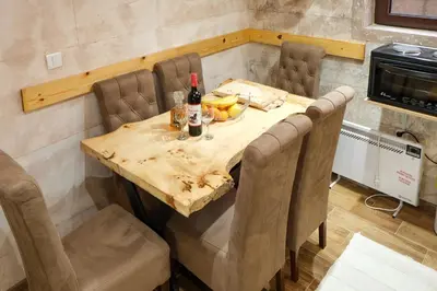 a table with bottles of wine and fruit on it at Villa Zagorka and mountain houses A, M, D in Kopaonik