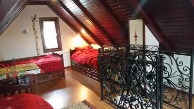 a living room with two beds and a balcony at Planinski Biser in Kopaonik