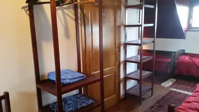 a room with a wooden closet with four shelves at Planinski Biser in Kopaonik