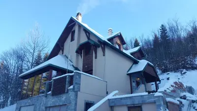 a house covered in snow on a mountain at Planinski Biser in Kopaonik
