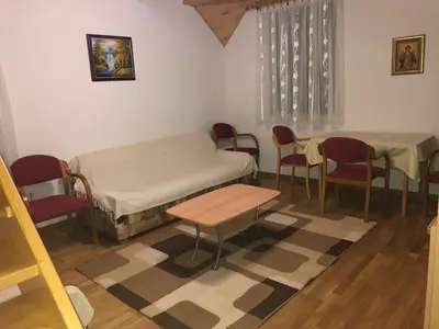 a room with a bed and a table and chairs at Stara Bačija in Kopaonik