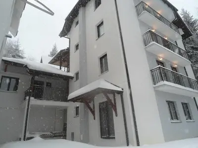a white building with snow on top of it at Stara Bačija in Kopaonik