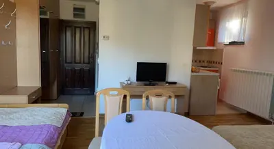 a small room with a table and a desk with a computer at Stara Bačija in Kopaonik