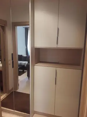 a cupboard in a living room with a mirror at Kamena Kuca Lux Apartment in Kopaonik