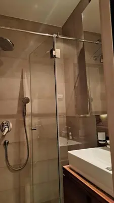 a bathroom with a glass shower and a sink at Kamena Kuca Lux Apartment in Kopaonik