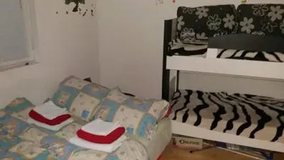 a small room with a bed and a bunk bed at Apartman ČAR 19 in Kopaonik