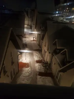 an empty alley at night with snow on the ground at Apartman ČAR 19 in Kopaonik