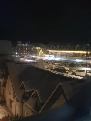 a view of a parking lot at night with lights at Apartman ČAR 19 in Kopaonik