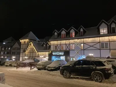 a car parked in front of a building with christmas lights at Apartman ČAR 19 in Kopaonik