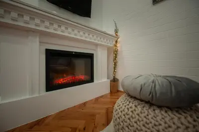 a living room with a fire place in a fireplace at Apartman Kopaonik Despotovic in Kopaonik