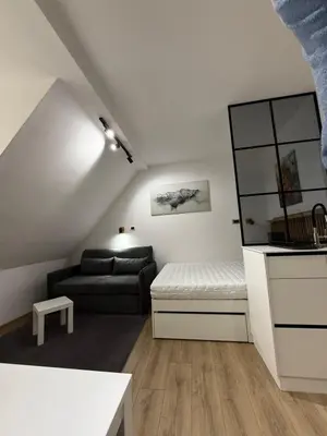 a living room with a couch and a table at Snow White apartments in Kopaonik