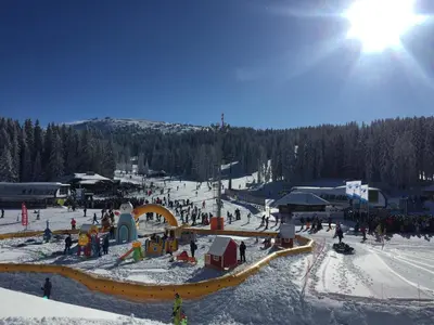 a group of people on a ski slope in the snow at MONI Luxury Apartments in Kopaonik