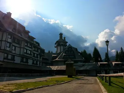a building with a tower on top of it at MONI Luxury Apartments in Kopaonik