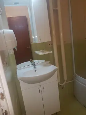 a bathroom with a white sink and a mirror at Hotel Sax Balkan in Dimitrovgrad