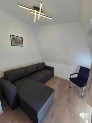 a living room with a couch and a ceiling fan at Hotel Sax Balkan in Dimitrovgrad