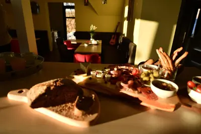 a sandwich and other food on a table at Dvori Apartments in Kopaonik