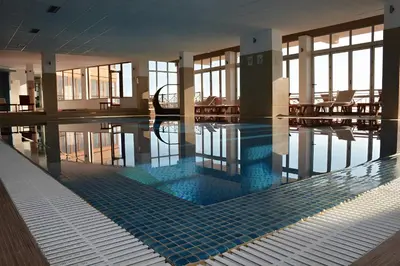 a swimming pool in a building with a pool at Modern Lux Apartment H8 at Milmari Resort in Kopaonik