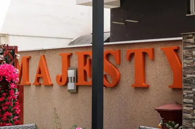 a large orange sign on the side of a building at Bed and Breakfast Majesty in Niš