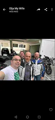 a group of men standing in front of a motorcycle at Bed and Breakfast Majesty in Niš