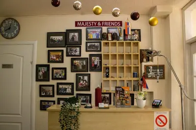 a room with a wall of pictures on the wall at Bed and Breakfast Majesty in Niš