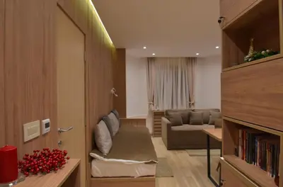 a living room with a couch and a living room with at Apartmani Prime in Kopaonik