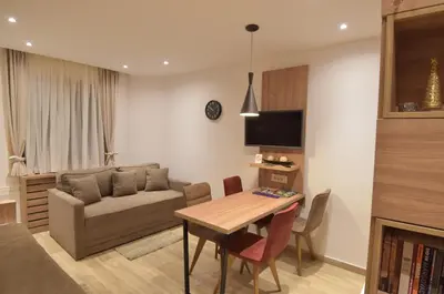 a living room with a couch and a table at Apartmani Prime in Kopaonik
