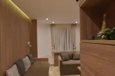 a living room with a couch and a chair at Apartmani Prime in Kopaonik